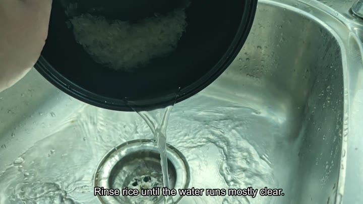 Rinsing rice in sink Rinsing rice in sink