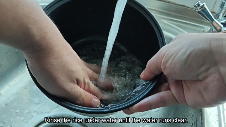 Rinsing rice under running faucet water Rinsing rice under running faucet water
