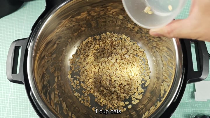 Rolling oats into stainless steel inner pot Rolling oats into stainless steel inner pot