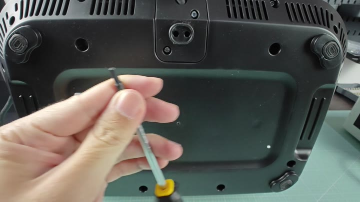 Screwdriver near air fryer base screws Screwdriver near air fryer base screws