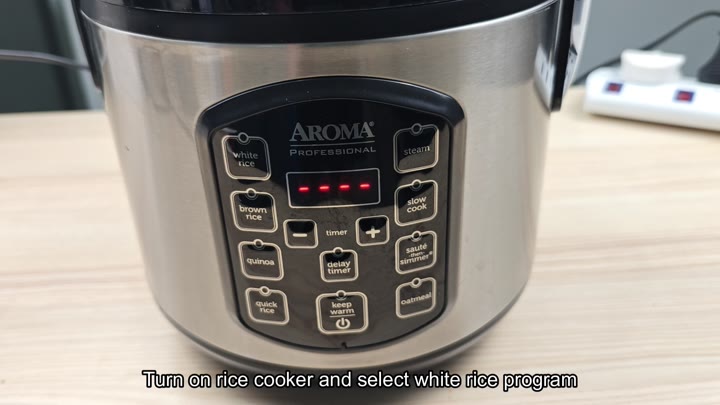 Selecting white rice program on cooker Selecting white rice program on cooker