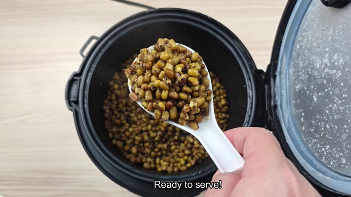 Serving cooked mung beans from pot Serving cooked mung beans from pot