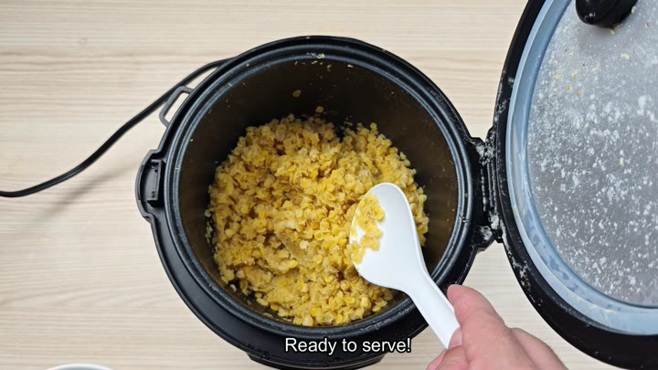 Serving cooked yellow lentils from pot Serving cooked yellow lentils from pot