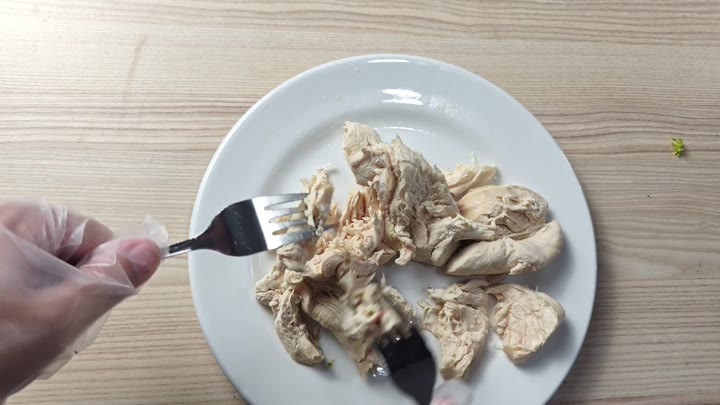 Shredding chicken with a fork Shredding chicken with a fork