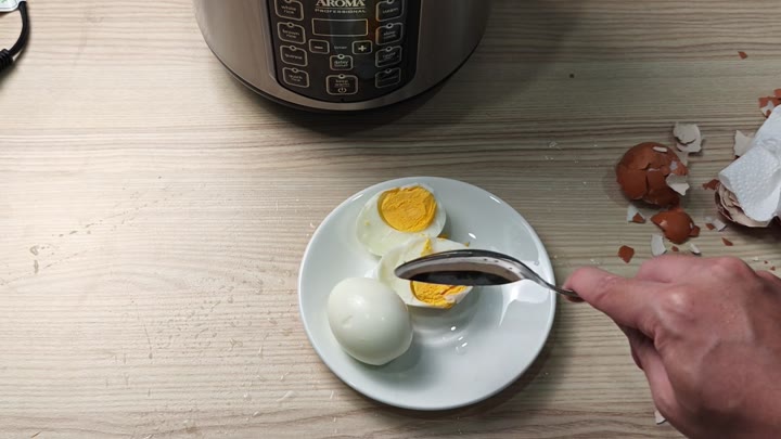 Slicing egg to show firm yolk Slicing egg to show firm yolk