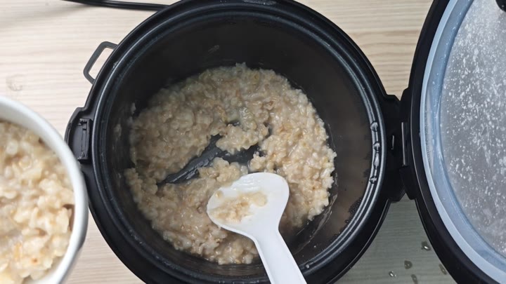 Spoon resting in cooked oatmeal Spoon resting in cooked oatmeal