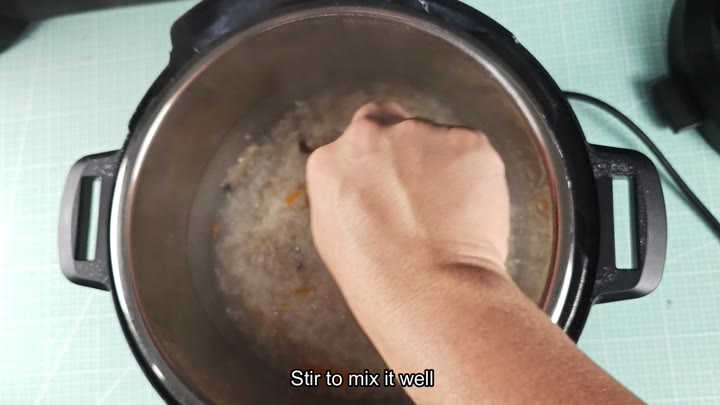 Stirring the creamy mushroom congee Stirring the creamy mushroom congee