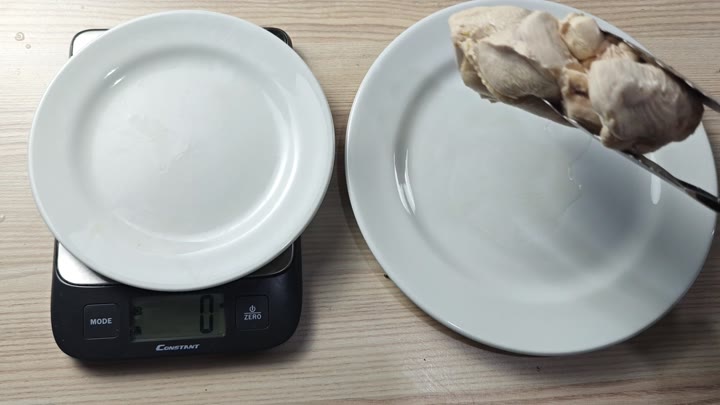 Weighing cooked chicken on scale Weighing cooked chicken on scale