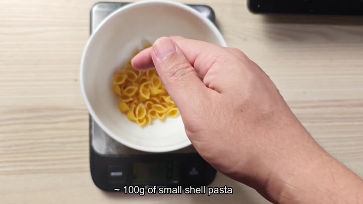 Weighing raw small shell pasta Weighing raw small shell pasta